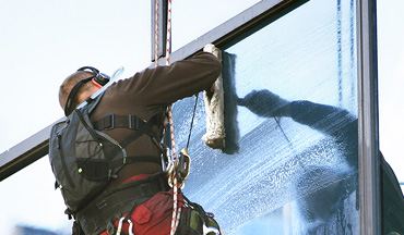 Gutter cleaning on a residential roof edge